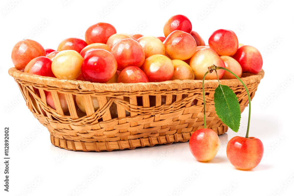 yellow cherries in a wicker basket isolated on white background yellow cherries in a wicker basket isolated on white background