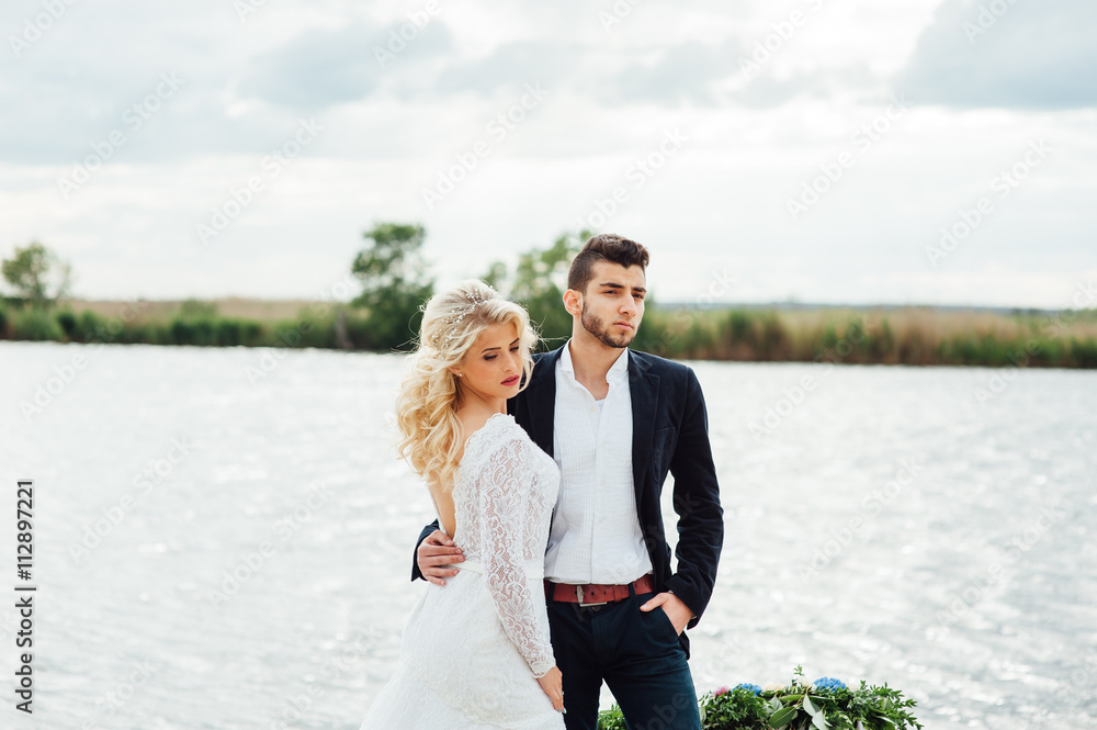 Bride and groom walking at the river Bride and groom walking at the river