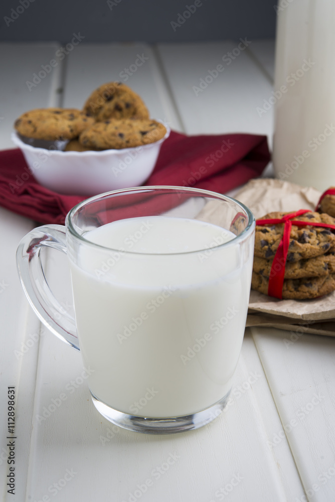 Very sweet retro bottle of milk with cookie on old table Very sweet retro bottle of milk with cookie on old table