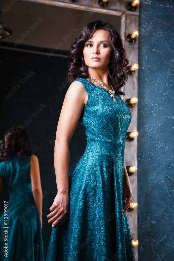 portrait of beautiful elegant young woman in gorgeous evening dress