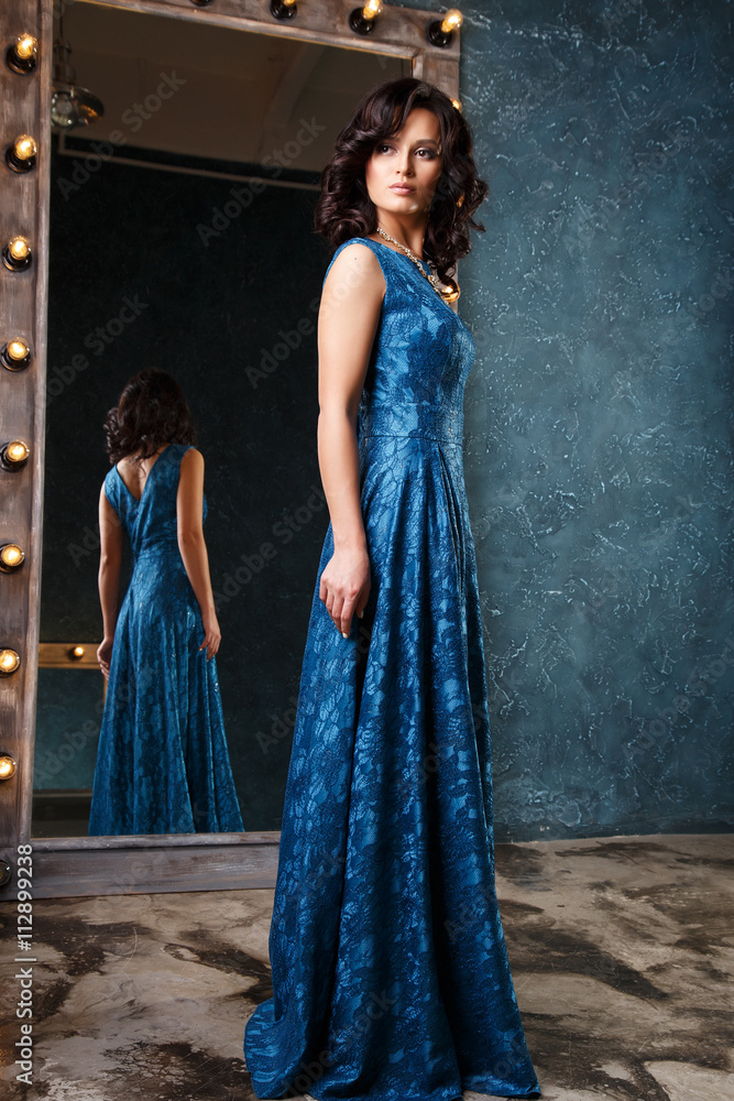 portrait of beautiful elegant young woman in gorgeous evening dress