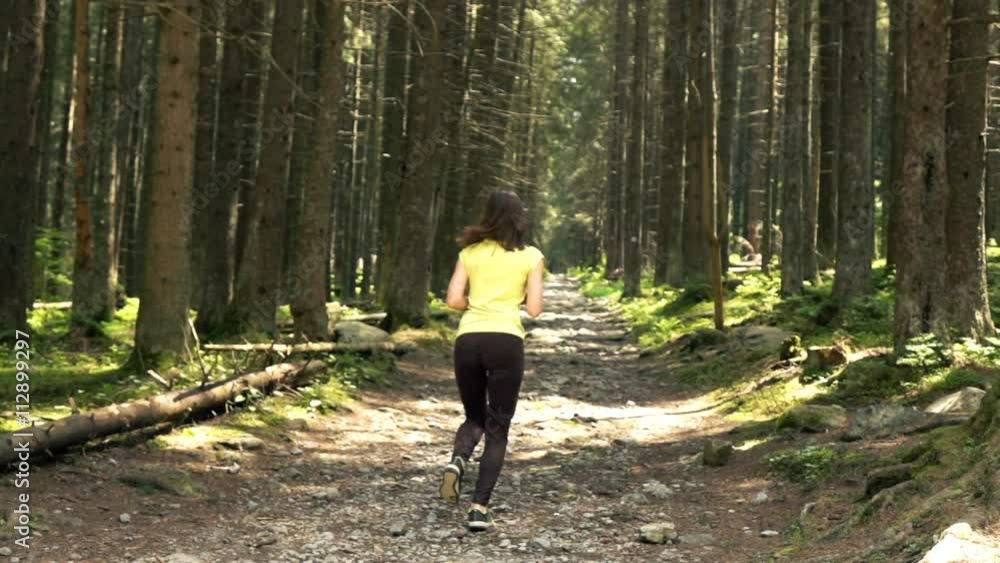 Young, sporty woman jogging in forest, super slow motion 240fps
Young, sporty woman jogging in forest, super slow motion 240fps