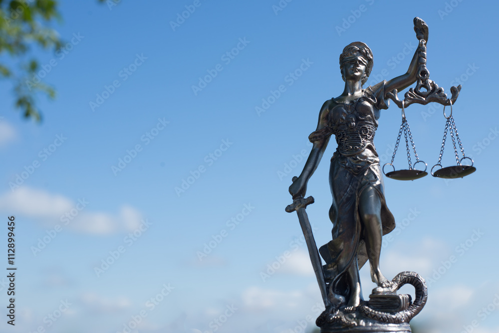 image of sculpture of themis, femida or justice goddess on bright blue sky copy space background