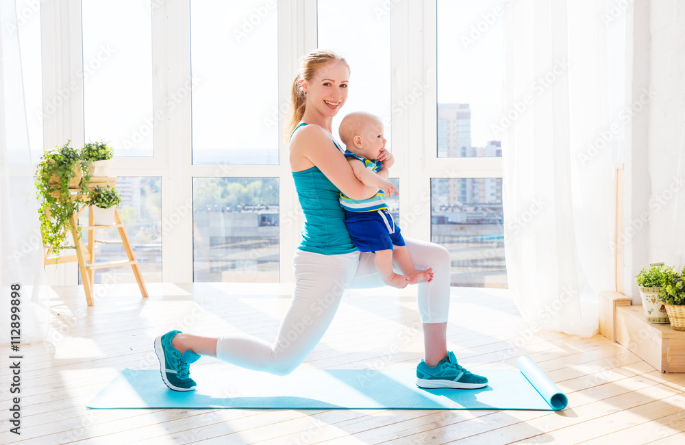sports mother is engaged in fitness and yoga with baby at home sports mother is engaged in fitness and yoga with baby at home