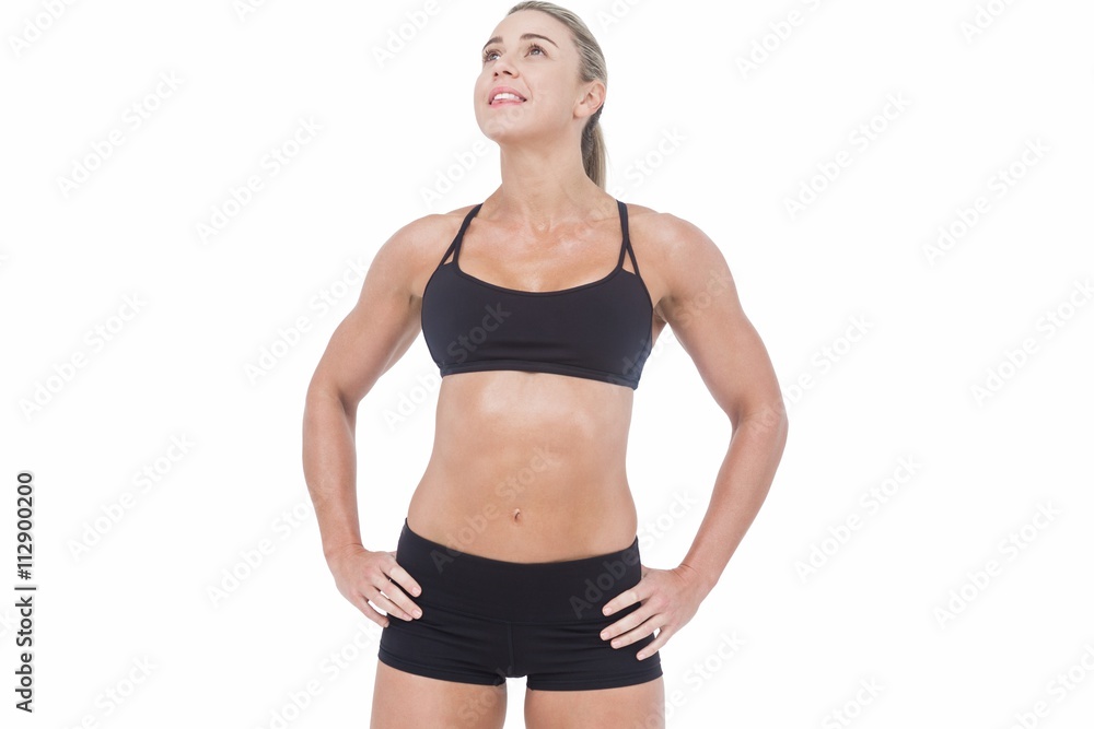 Female athlete posing with hands on hip Female athlete posing with hands on hip