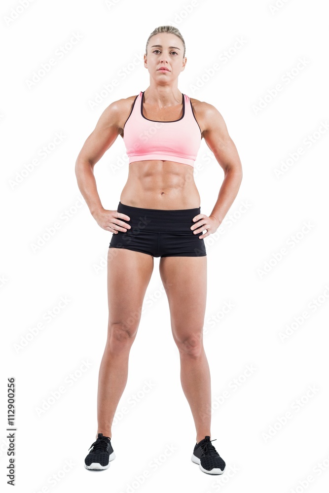 Female athlete posing with hands on hip Female athlete posing with hands on hip