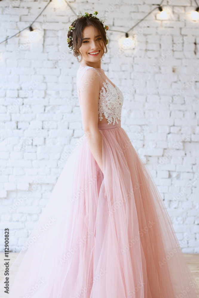 Bride in a tender light pink wedding dress in a morning. Fashion beauty portrait Bride in a tender light pink wedding dress in a morning. Fashion beauty portrait