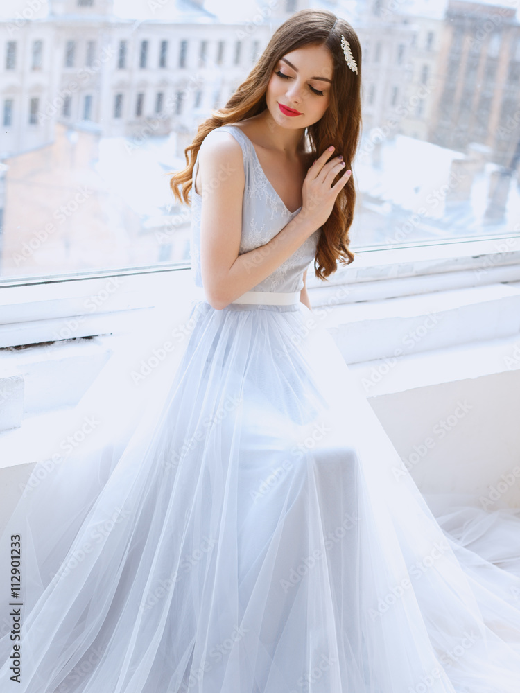 Bride in a tender light blue wedding dress in a morning. Fashion beauty portrait Bride in a tender light blue wedding dress in a morning. Fashion beauty portrait