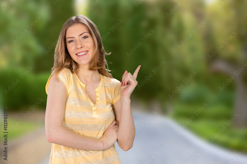 Young elegant woman pointing at white background Young elegant woman pointing at white background