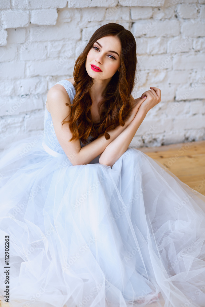 Naklejka premium Bride in a tender light blue wedding dress in a morning. Fashion beauty portrait
