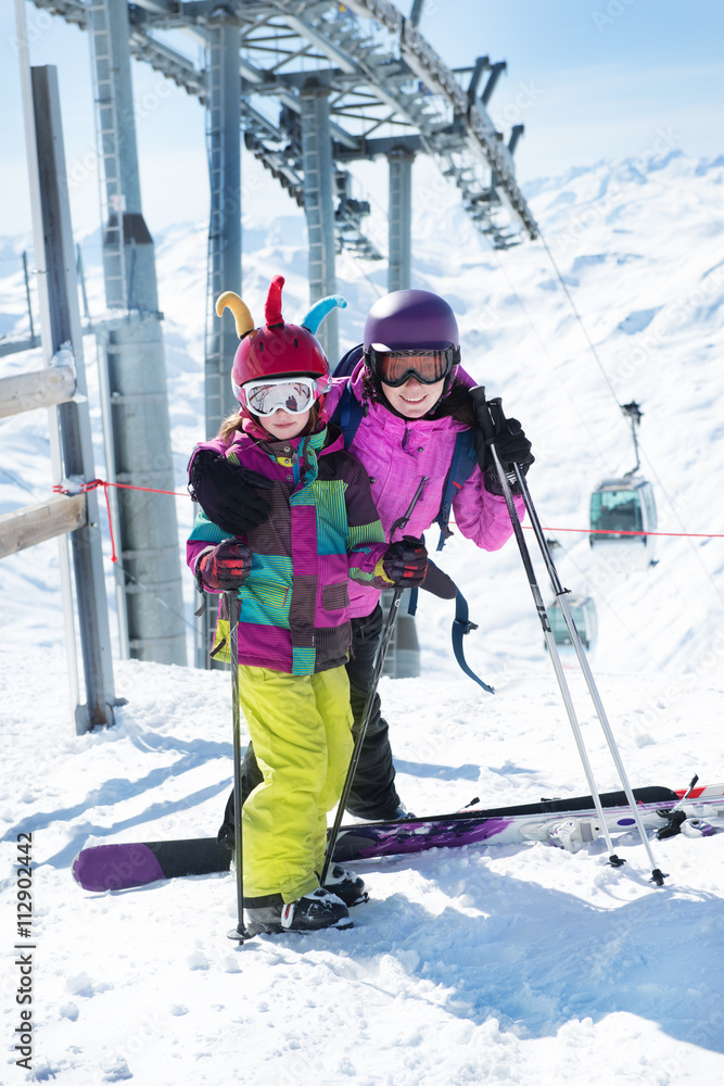 Mother and daughter with skis