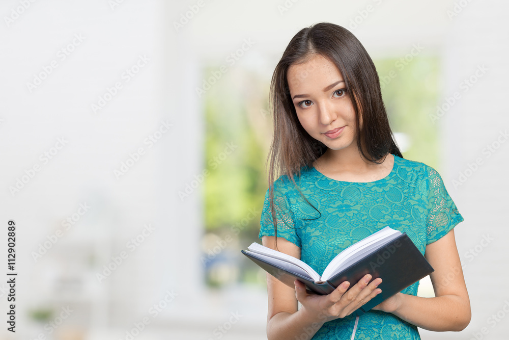 Woman university / college student holding book Woman university / college student holding book