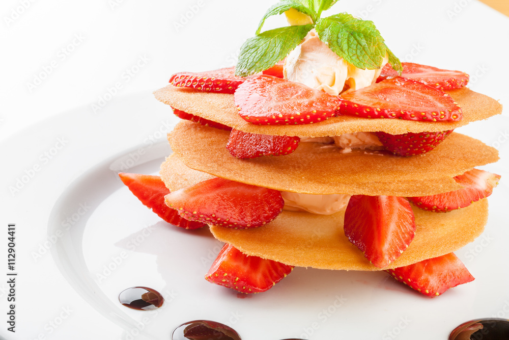 waffles with caramel sauce, whipped cream and strawberries isolated on white background waffles with caramel sauce, whipped cream and strawberries isolated on white background