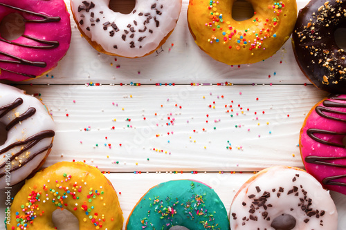Photo donuts on a wooden background and space for text