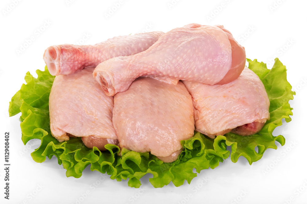 Raw chicken legs and lettuce isolated on white. Raw chicken legs and lettuce isolated on white.