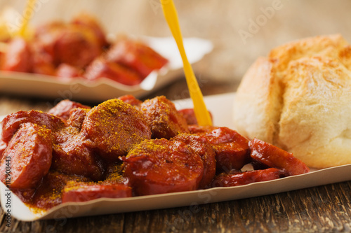 Photography Traditional German currywurst, served on disposable paper tray w
