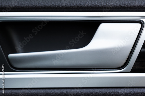 Inner door handle, modern car interior detail © fotofabrika