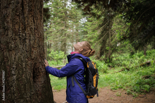 female tourist in the forest near old big cedar © Dmitry_Evs