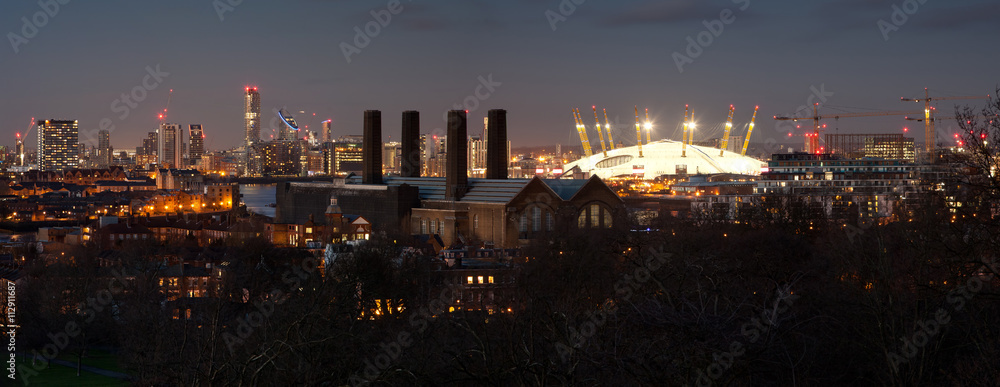 London, UK - JANUARY 7, 2016: Panorama of Canary Wharf in night. View includes the park, National Maritime Museum, Royal chapel, Painted hall and O2