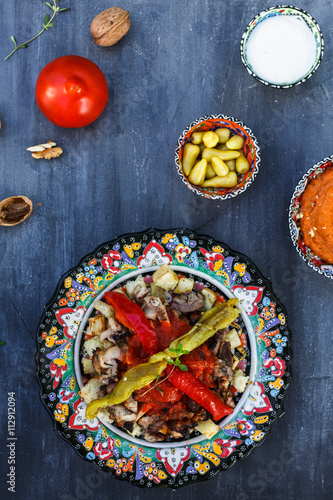 Traditional Turkish Bursa iskender kebap doner served with red sauce and yogurt
