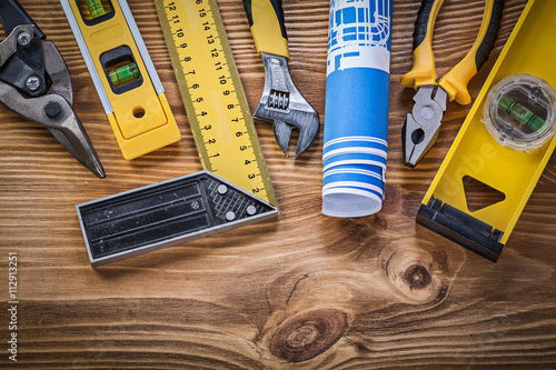 Assortment of construction tools on vintage wooden board directl photo