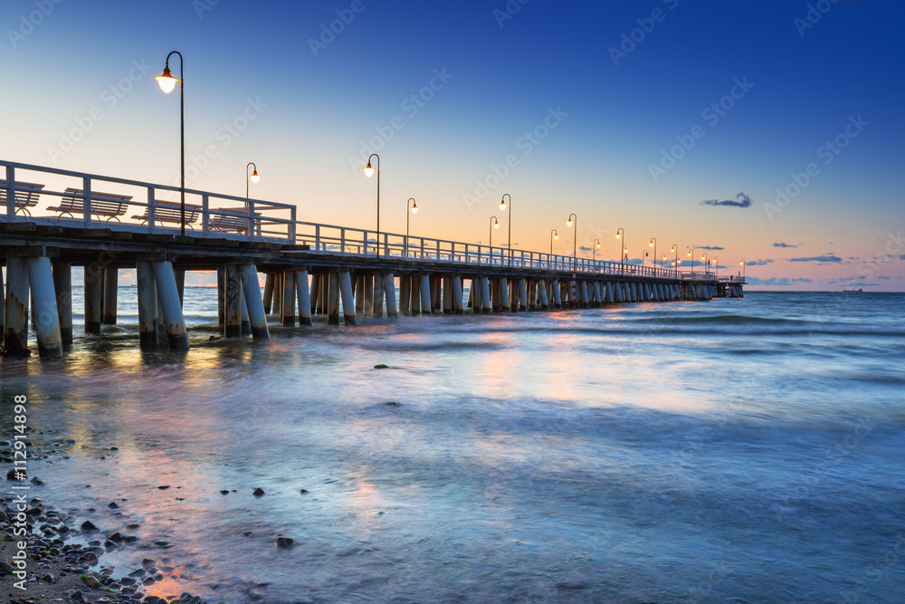 Baltic sea with pier in Gdynia Orlowo at sunrise, Poland
