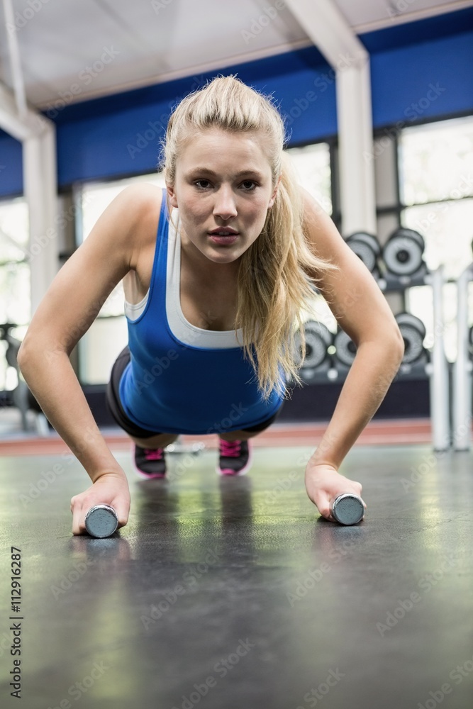Determined woman doing push ups Determined woman doing push ups