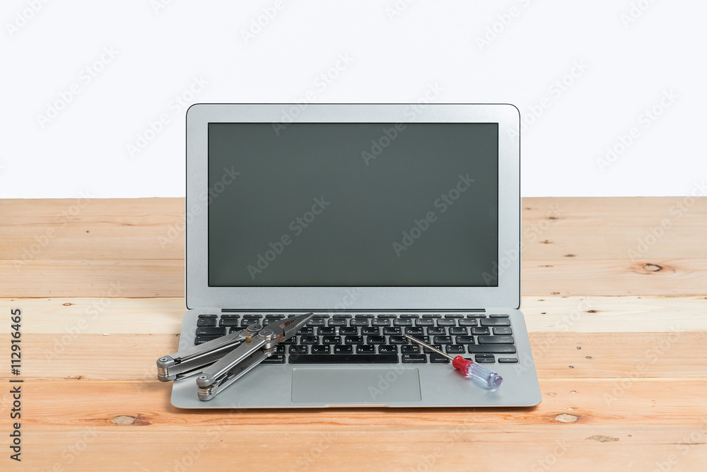 wrench on laptop concept fixing it
wrench on laptop concept fixing it