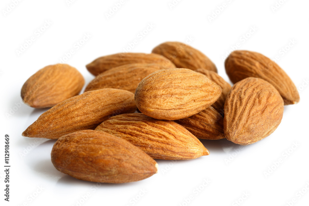 Pile of whole almonds isolated on white. Pile of whole almonds isolated on white.