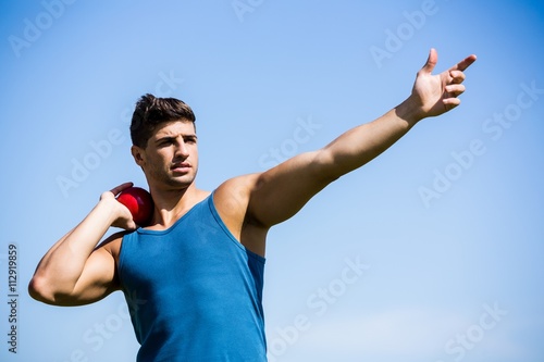 Athlete about to throw shot put ball photo