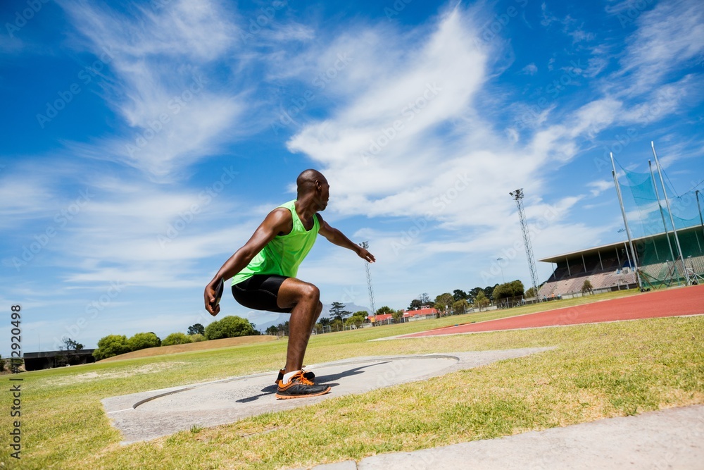 Fototapeta premium Male athlete preparing to throw shot put ball