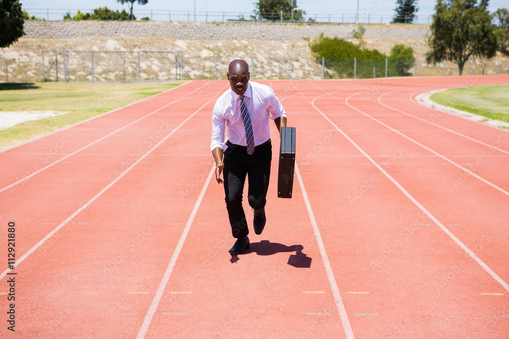 Businessman running on a running track Businessman running on a running track