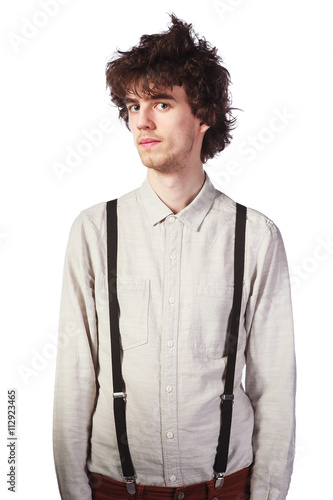 Portrait of a handsome guy in a white shirt with suspenders over a white background