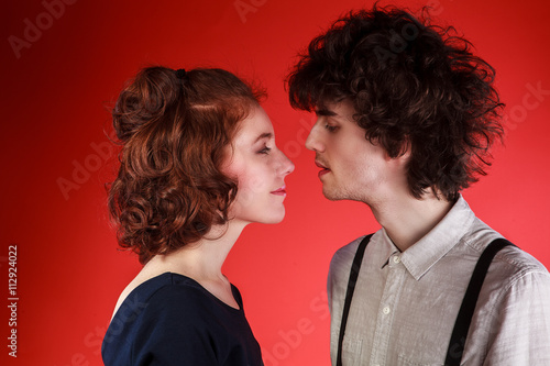 Portrait of a beautiful young couple love romance red background