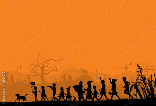 Silhouette of children playing on Halloween night