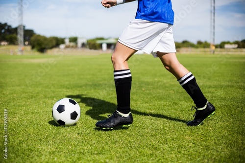 Fototapeta Naklejka Na Ścianę i Meble -  Female football player practicing soccer