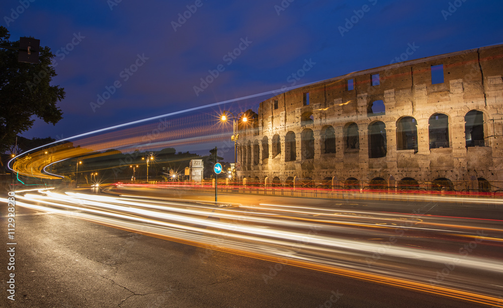 cars trails near the colosseum in Rome in Italy cars trails near the colosseum in Rome in Italy