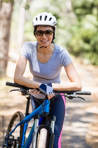 Woman smiling and posing with her bike