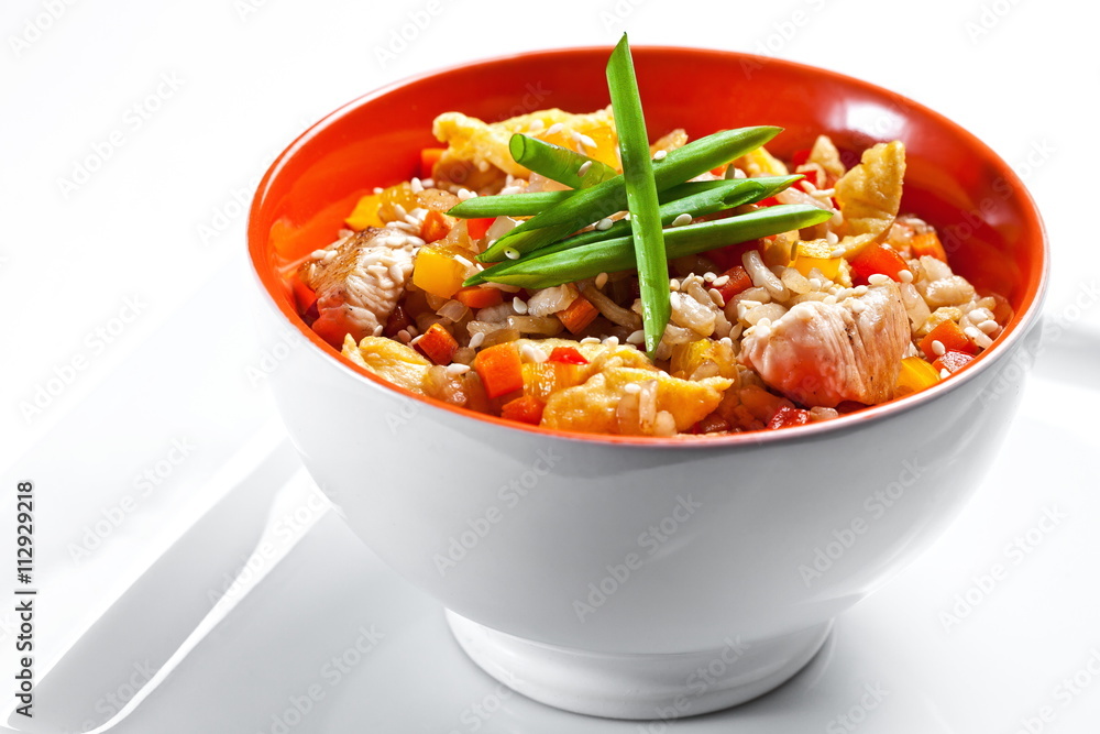 Fried rice with chicken and vegetables on white background Fried rice with chicken and vegetables on white background