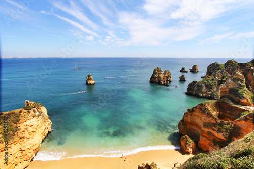 Rocky beach at sunset, Lagos, Portugal. Travel and business background photo