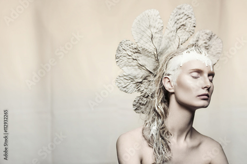 Woman with leaf headdress and eyes closed, portrait