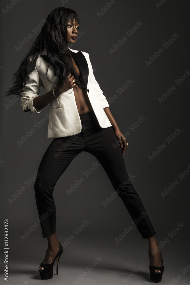 Woman posing with jacket undone, wide stance Woman posing with jacket undone, wide stance