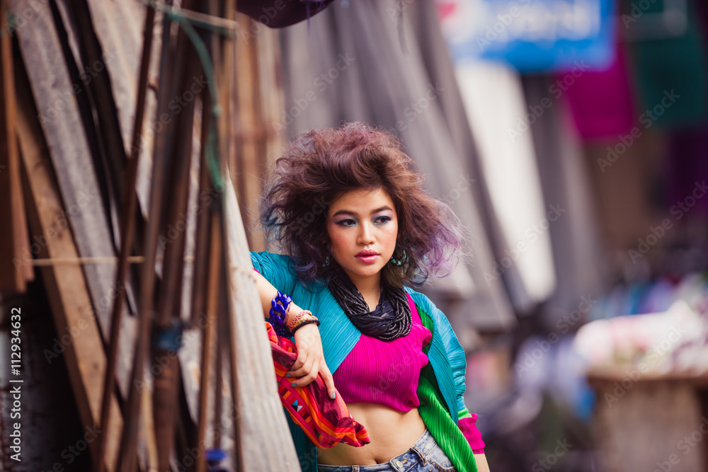 Attractive young Asian girl posing in the middle of the market i