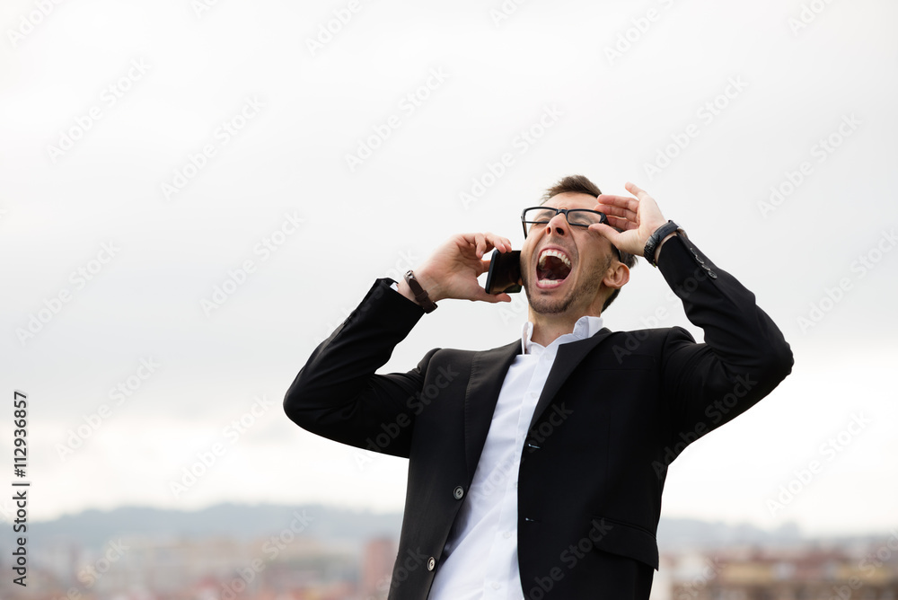 Businessman shouting during cellphone call outside. Businessman shouting during cellphone call outside.