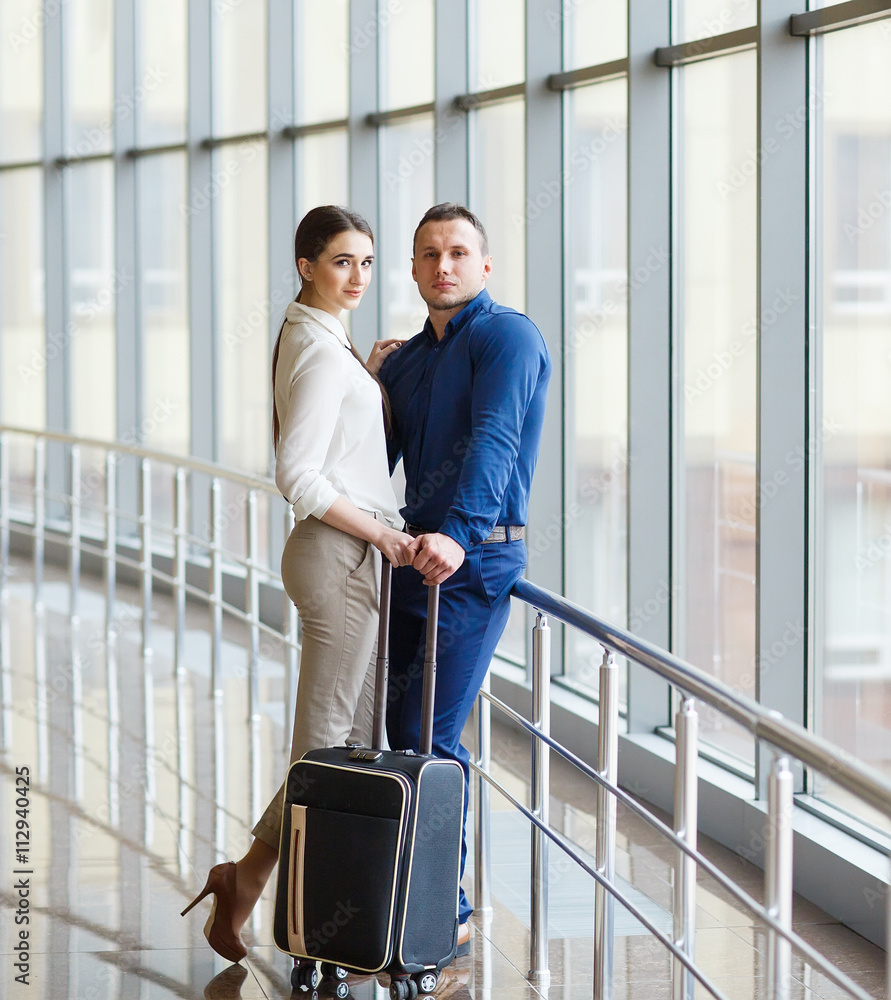 Couple in love on vacation. Couple standing in the airport. Couple in love on vacation. Couple standing in the airport.