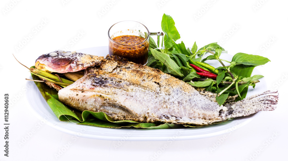 Grilled fish with salt on white plate Grilled fish with salt on white plate