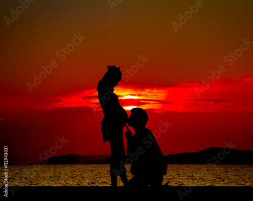 Silhouetted of Young father talk to son 