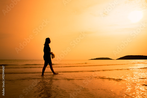 Silhouette happy woman walking on beach, Happy young woman walki