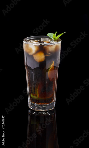 Rum and Cola Cuba Libre with Lime and Ice ver black background