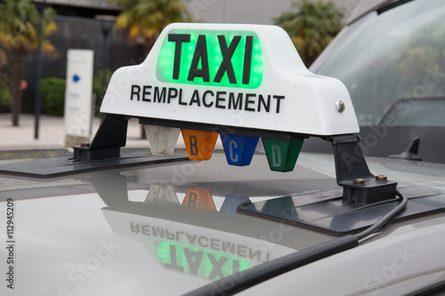 Green taxi sign in France on the car